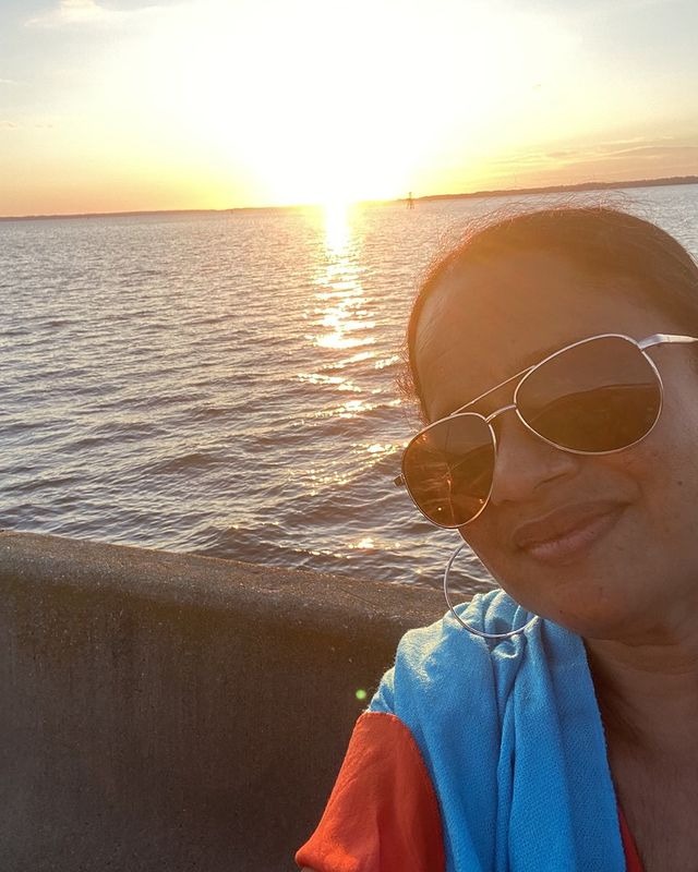 Picture of Tracy Vilar enjoying a sunset view in a ocean.